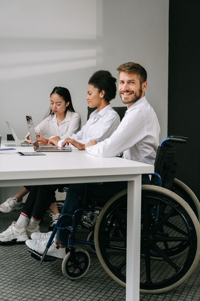 A diverse team of professionals working together at a modern office table, promoting inclusion.